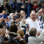FILE PHOTO: Pope Francis waves at the end of the Palm Sunday mass at Saint Peter's Square at the Vatican, March 20, 2016. REUTERS/Tony Gentile/File Photo