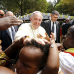 FILE PHOTO: Pope Francis blesses a child as he visits the refugee camp of Saint Sauveur in Bangui, Central African Republic, November 29, 2015. REUTERS/Stefano Rellandini/File Photo