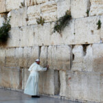 FILE PHOTO: Pope Francis touches the stones of the Western Wall, Judaism's holiest prayer site, in Jerusalem's Old City May 26, 2014. REUTERS/Ronen Zvulun/File Photo