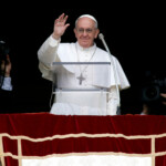FILE PHOTO: Newly elected Pope Francis appears at the window of his future private apartment to bless the faithful, gathered below in St. Peter's Square, during the Sunday Angelus prayer at the Vatican March 17, 2013. REUTERS/Tony Gentile/File Photo