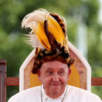 FILE PHOTO: Pope Francis sits with headgear as he visits Vanimo, Papua New Guinea, September 8, 2024. REUTERS/Guglielmo Mangiapane/File Photo