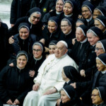 FILE PHOTO: Pope Francis sits in between nuns on the day of a weekly general audience in Paul VI hall at the Vatican, February 5, 2025. REUTERS/Remo Casilli/File Photo