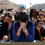 People pray while waiting for the start of the funeral mass of Pope Francis, in St. Peter's Square at the Vatican, April 26, 2025. REUTERS/Susana Vera TPX IMAGES OF THE DAY