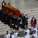 The coffin of Pope Francis is carried during the funeral Mass of Pope Francis in St. Peter's Square at the Vatican, April 26, 2025. REUTERS/Kai Pfaffenbach