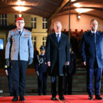 Outgoing German Chancellor Olaf Scholz stands next to Defence Minister Boris Pistorius during the military ceremonial Grand Tattoo ("Grosser Zapfenstreich") of the German "Bundeswehr", the armed forces, in his honour, at the Defence Ministry in Berlin, Germany May 5, 2025. REUTERS/Nadja Wohlleben