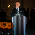Outgoing German Chancellor Olaf Scholz speaks during a military Grand Tattoo ("Grosser Zapfenstreich") of the German armed forces Bundeswehr at the Defence Ministry in Berlin, Germany May 5, 2025. Michael Kappeler/Pool via REUTERS