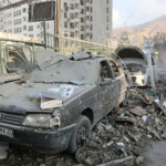 People gather near damaged vehicles in the aftermath of Israeli strikes, in Tehran, Iran, June 13, 2025. Majid Asgaripour/WANA (West Asia News Agency) via REUTERS
