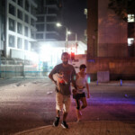 Israelis react at an impact site following a missile attack from Iran on Israel, at Tel Aviv, Israel, June 13, 2025 REUTERS/Itai Ron