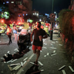 A man walks at an impact site following missile attack from Iran on Israel, in Ramat Gan, Israel June 13, 2025 REUTERS/Itai Ron