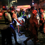 Rescue and security personnel carry a wounded person at an impact site following missile attack from Iran on Israel, in Ramat Gan, Israel June 13, 2025 REUTERS/Itai Ron