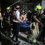 Rescue and security personnel carry a wounded person at an impact site following missile attack from Iran on Israel, in Ramat Gan, Israel June 13, 2025 REUTERS/Itai Ron