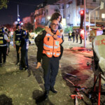 A rescue personal carry a woman at an impact site following missile attack from Iran on Israel, in Ramat Gan, Israel June 13, 2025 REUTERS/Itai Ron