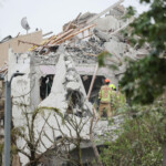 Rescue personnel work at an impact site following missile attack from Iran on Israel, in Rishon LeZion, Israel, June 14, 2025. REUTERS/Ronen Zvulun
