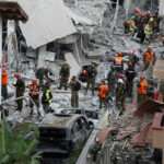 Rescue personnel work at an impact site following missile attack from Iran on Israel, in Rishon LeZion, Israel, June 14, 2025. REUTERS/Ronen Zvulun