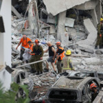 Rescue personnel work at an impact site following missile attack from Iran on Israel, in Rishon LeZion, Israel, June 14, 2025. REUTERS/Ronen Zvulun