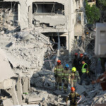Rescue personnel work at an impact site following missile attack from Iran on Israel, in Rishon LeZion, Israel, June 14, 2025. REUTERS/Ronen Zvulun