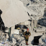 A rescue personnel works at an impact site following missile attack from Iran on Israel, in Rishon LeZion, Israel, June 14, 2025. REUTERS/Ronen Zvulun
