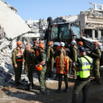 Rescue personnel work at an impact site following missile attack from Iran on Israel, in Rishon LeZion, Israel, June 14, 2025. REUTERS/Ronen Zvulun