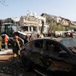Rescue personnel work at an impact site following missile attack from Iran on Israel, in Rishon LeZion, Israel, June 14, 2025. REUTERS/Ronen Zvulun