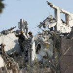 Rescue personnel work at an impact site following missile attack from Iran on Israel, in Rishon LeZion, Israel, June 14, 2025. REUTERS/Ronen Zvulun