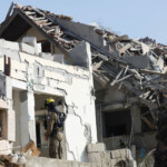 A rescue personnel works at an impact site following missile attack from Iran on Israel, in Rishon LeZion, Israel, June 14, 2025. REUTERS/Ronen Zvulun