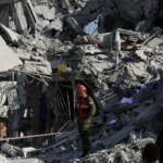 Rescue personnel work at an impact site following missile attack from Iran on Israel, in Rishon LeZion, Israel, June 14, 2025. REUTERS/Ronen Zvulun