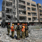 Rescue personnel work at an impact site following missile attack from Iran on Israel, in Ramat Gan, Israel, June 14, 2025. REUTERS/Ronen Zvulun