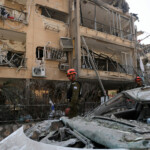 Rescue personnel work at an impact site following missile attack from Iran on Israel, in Ramat Gan, Israel, June 14, 2025. REUTERS/Ronen Zvulun