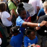 Mildred Pierre and her daughters Antoynette Pierre and Abygail Pierre hand out information during the "No Kings" rally near the Georgia State Capitol in Atlanta, Georgia, U.S., June 14, 2025. REUTERS/Alyssa Pointer