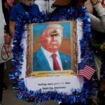 A person holds a placard with an image depicting U.S. President Donald Trump during the "No Kings" rally near the Georgia State Capitol in Atlanta, Georgia, U.S., June 14, 2025. REUTERS/Alyssa Pointer