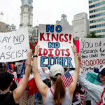 People hold placards as they participate in the "No Kings" protest in Philadelphia, Pennsylvania, U.S., June 14, 2025. REUTERS/Rachel Wisniewski