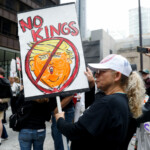 A woman holds a placard depicting U.S. President Donald Trump as people gather to attend the "No Kings" rally at the Daley Plaza in downtown Chicago, Illinois, U.S., June 14, 2025. REUTERS/Octavio Jones