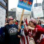 People react as they gather to attend the "No Kings" rally at the Daley Plaza in downtown Chicago, Illinois, U.S., June 14, 2025. REUTERS/Octavio Jones