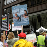 People hold placards as they gather to attend the "No Kings" rally at the Daley Plaza in downtown Chicago, Illinois, U.S., June 14, 2025. REUTERS/Octavio Jones