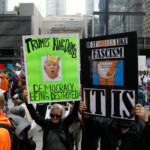 People hold placards as they gather to attend the "No Kings" rally at the Daley Plaza in downtown Chicago, Illinois, U.S., June 14, 2025. REUTERS/Octavio Jones