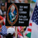 A demonstrator holds a placard during a "No Kings Day" protest, in Los Angeles, California, U.S., June 14, 2025. REUTERS/MIKE BLAKE