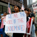 Giselle Sanchez, 16, holds a placard as people convene for the start of the "No Kings" rally at the Daley Plaza in downtown Chicago, Illinois, U.S., June 14, 2025. REUTERS/Octavio Jones