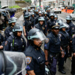 NYPD officers wait for instructions as people start marching during the "No Kings Day" protest, in New York City, U.S., June 14, 2025. REUTERS/Eduardo Munoz