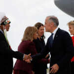 Bearspaw First Nation Chief Darcy Dixon greets Canada's Prime Minister Mark Carney as he arrives before world leaders meet in Kananaskis for the G7 leaders' summit, at Calgary International Airport in Calgary, Alberta, Canada June 15, 2025. REUTERS/Amber Bracken/Pool