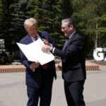 U.S. President Donald Trump holds a signed Trade Agreement with Britain during a meeting with British Prime Minister Keir Starmer, at the G7 summit, in Kananaskis, Alberta, Canada June 16, 2025. Stefan Rousseau/Pool via REUTERS