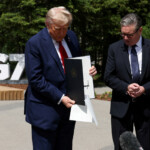 U.S. President Donald Trump holds a signed Trade Agreement with Britain during a meeting with British Prime Minister Keir Starmer, at the G7 summit, in Kananaskis, Alberta, Canada, June 16, 2025. REUTERS/Suzanne Plunkett/Pool