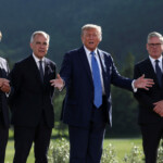 U.S. President Donald Trump speaks to a reporter while standing with French President Emmanuel Macron, Canada Prime Minister Mark Carney and British Prime Minister Keir Starmer during a family photo at the G7 Summit in Kananaskis, Alberta, Canada, June 16, 2025. REUTERS/Kevin Lamarque