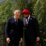 Canadian Prime Minister Mark Carney and World Bank President Ajay Banga talk as they stand in preparation for a family photo during the G7 Leaders' Summit in Kananaskis, in Alberta, Canada, June 17, 2025. REUTERS/Amber Bracken