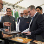Britain's Prime Minister Keir Starmer and Prime Minister Narendra Modi of India speak to a trader during a business showcase event at Chequers near Aylesbury, England, Thursday, July 24, 2025. Kin Cheung/Pool via REUTERS