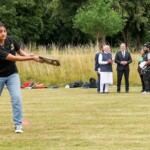 Britain's Prime Minister Keir Starmer looks on as Prime Minister Narendra Modi holds a Cricket bat, signed by Indian Cricket players, as they meet school children at Chequers near Aylesbury, England