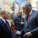 Russian President Vladimir Putin talks to Kremlin spokesman Dmitry Peskov after a meeting with U.S. President Donald Trump at Joint Base Elmendorf-Richardson in Anchorage, Alaska, U.S., August 15, 2025. Sputnik/Gavriil Grigorov/Pool via REUTERS