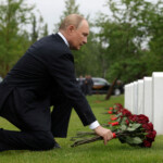 Russian President Vladimir Putin lays flowers at the graves of Soviet soldiers at Fort Richardson National Cemetery near Anchorage, Alaska, U.S., August 15, 2025. Sputnik/Gavriil Grigorov/Pool via REUTERS