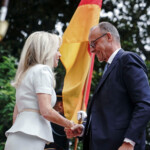U.S. Chief of Protocol Monica Crowley greets Germany's Chancellor Friedrich Merz as he arrives at the White House amid negotiations to end the Russian war in Ukraine, in Washington, D.C., U.S., August 18, 2025. REUTERS/Nathan Howard