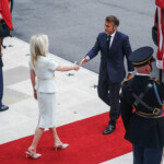 U.S. Chief of Protocol Monica Crowley greets French President Emmanuel Macron as he arrives at the White House amid negotiations to end the Russian war in Ukraine, in Washington, D.C., U.S., August 18, 2025. REUTERS/Nathan Howard