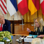 U.S. President Donald Trump speaks with Italian Prime Minister Giorgia Meloni during a meeting with Ukrainian President Volodymyr Zelenskiy (not pictured) and European leaders amid negotiations to end the Russian war in Ukraine, at the White House in Washington, D.C., U.S., August 18, 2025. REUTERS/Al Drago
